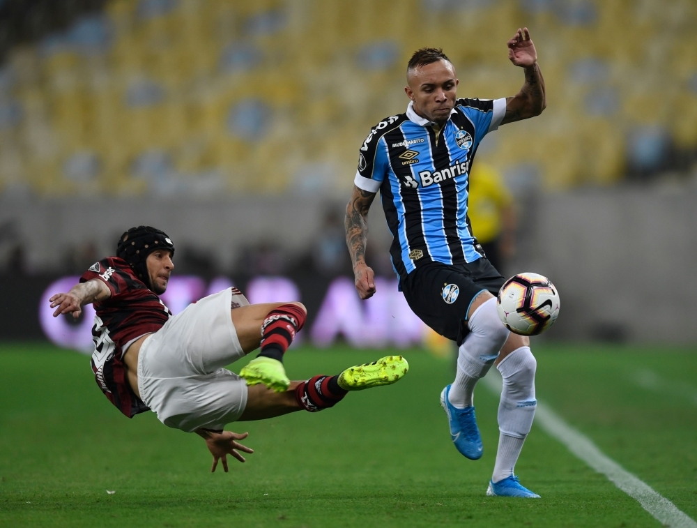 Flamengo's Rafinha and Gremio's Everton vie for the ball during their Copa Libertadores semifinal second leg football match, at Maracana stadium in Rio de Janeiro, Brazil, on Wednesday. — AFP