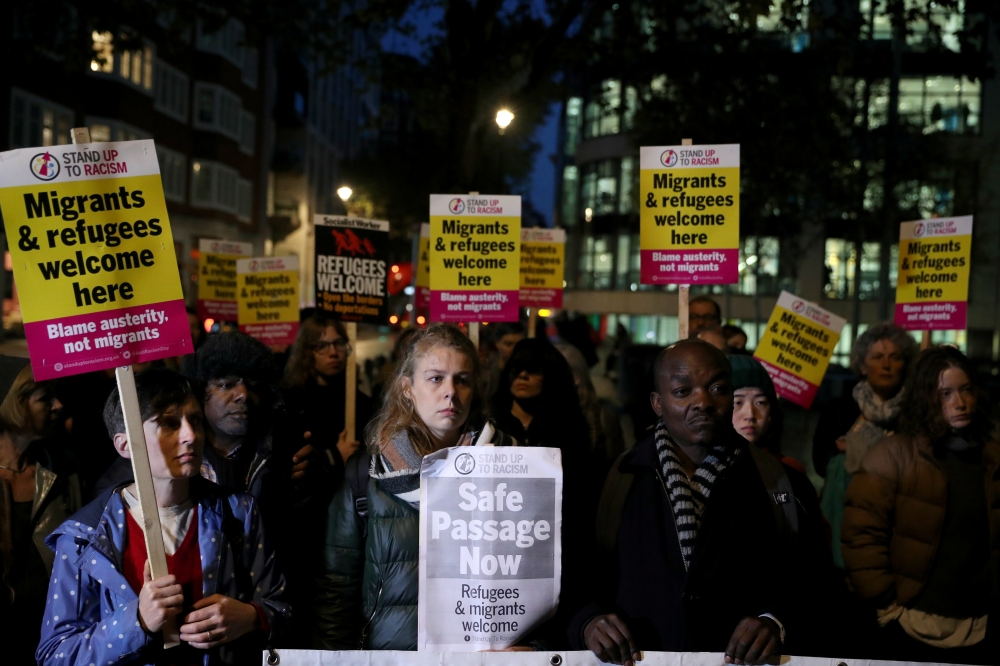 Anti-racism campaigners take part in a vigil, following the discovery of 39 bodies in a truck container on Wednesday, outside the Home Office in London, Britain Thursday. — Reuters
