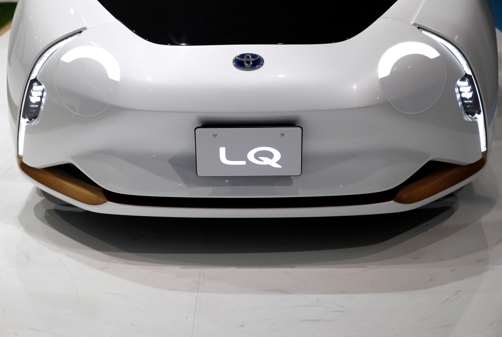 The headlights of Toyota's electric LQ Concept car are pictured at the Tokyo Motor Show, in Tokyo, Japan, on Friday. — Reuters