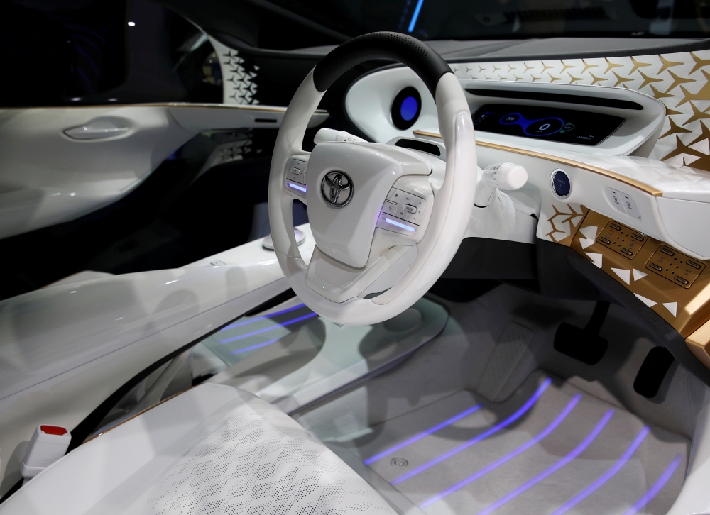 The headlights of Toyota's electric LQ Concept car are pictured at the Tokyo Motor Show, in Tokyo, Japan, on Friday. — Reuters
