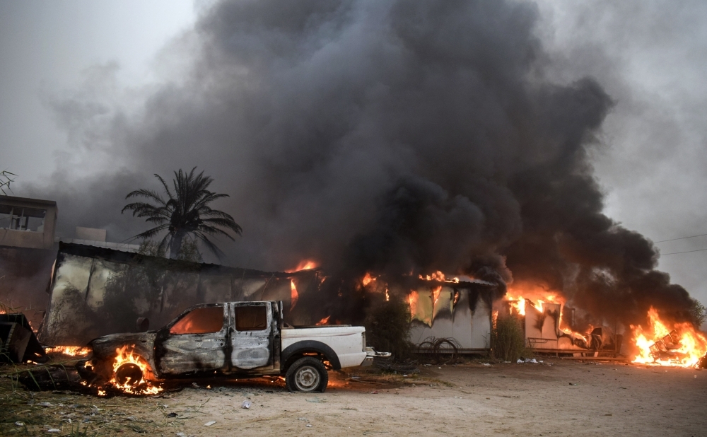 A view of the burning local government headquarters in Nasiriyah, the capital of Iraq's southern province of Dhi Qar, on Friday, amid a wave of anti-government demonstrations across the country. — AFP