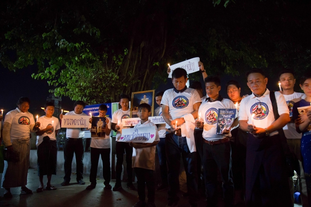 People hold candles and pray for the Myanmar migrant workers Zaw Lin and Win Zaw Tun (unseen), which were sentenced to death for rape and murder by Thai courts, as they demand for the royal pardon to his Majesty, in Yangon on Friday. Myanmar migrant workers Zaw Lin and Win Zaw Tun were sentenced to death by Thai courts for the rape and murder of Hannah Witheridge, 23, and the killing of David Miller, 24. — AFP