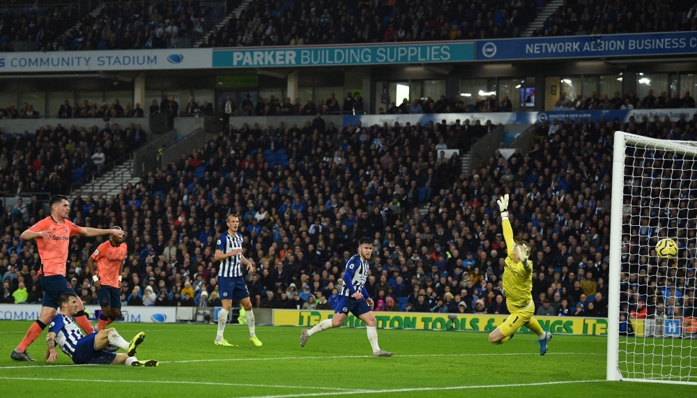 Brighton's German midfielder Pascal Gross (L) puts the ball past Everton's English goalkeeper Jordan Pickford (R) but the goal was ruled out by the Video Assistant Referee (VAR) during the English Premier League football match between Brighton and Hove Albion and Everton at the American Express Community Stadium in Brighton, southern England, on Saturday. — AFP 