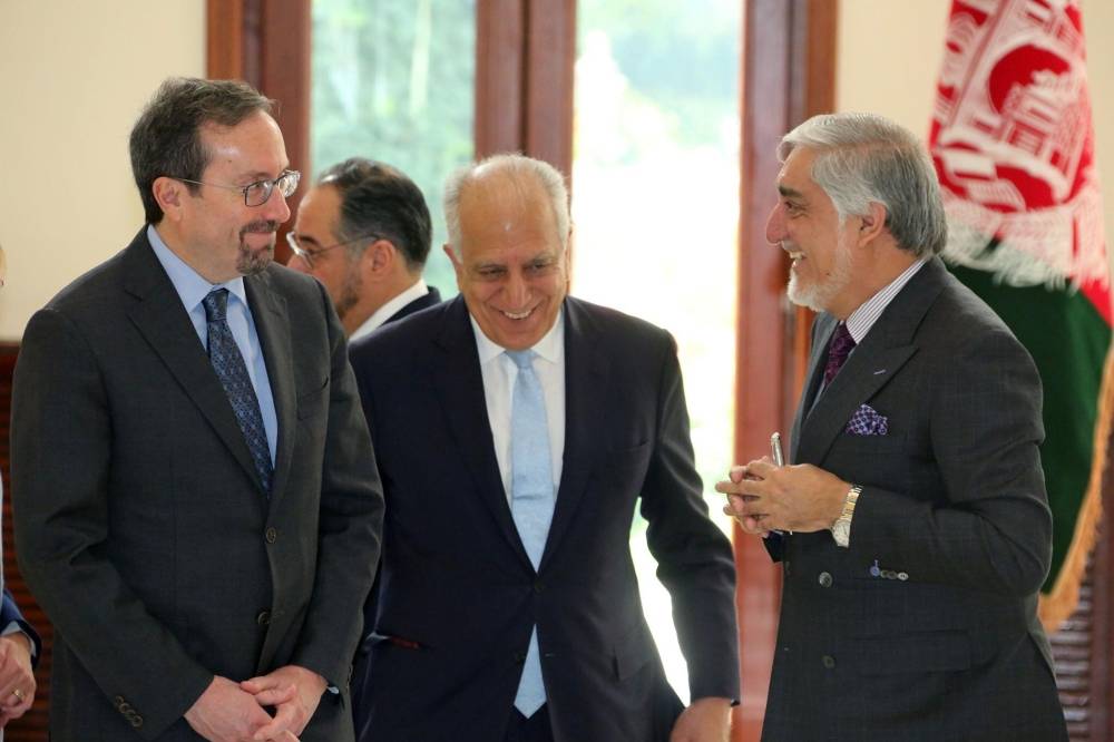 US special representative for Afghanistan, Zalmay Khalilzad, US Ambassador John Bass and Afghanistan Chief Executive Abdullah Abdullah have a chat before their meeting in Kabul, Sunday. — Reuters