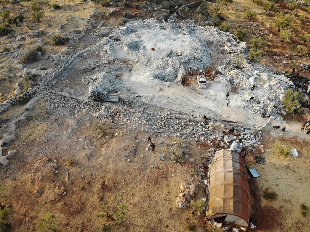 An aerial view taken on Sunday shows the site that was hit by helicopter gunfire which reportedly killed nine people near the northwestern Syrian village of Barisha in the Idlib province along the border with Turkey, where 