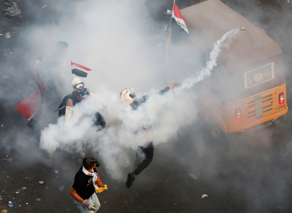 Iraqis take part in an anti-government demonstration, on Monday in the central city of Hila. The Iraqi army today announced it would impose an overnight curfew in the capital as students and schoolchildren joined spreading protests to demand an overhaul of the government. Swaths of Iraq have been engulfed by demonstrations over unemployment and corruption this month that have evolved into demands for regime change. — AFP