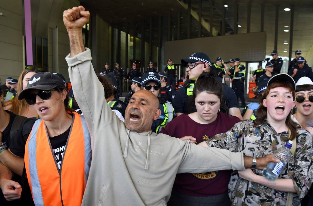 Climate change protesters link arms as they attempt to blockade the International Mining and Resources Conference (IMARC) being held in Melbourne on Tuesday. -Courtesy photo