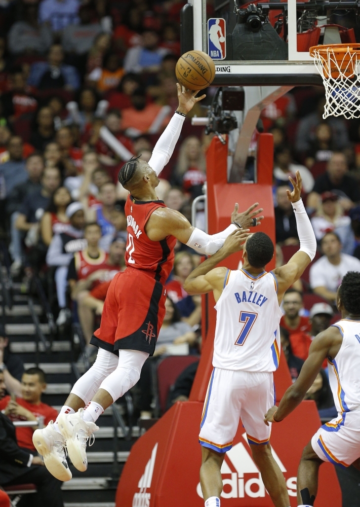 Russell Westbrook (0) of the Houston Rockets drives to the basket over Darius Bazley (7) of the Oklahoma City Thunder for a layup during the fourth quarter at Toyota Center in Houston, Texas, on Monday. — AFP