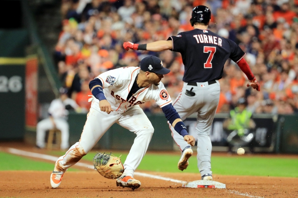 HOUSTON, TEXAS - OCTOBER 29: Trea Turner #7 of the Washington Nationals is called out on runner interference for colliding with Yuli Gurriel #10 of the Houston Astros during the seventh inning in Game Six of the 2019 World Series at Minute Maid Park on October 29, 2019 in Houston, Texas.   Mike Ehrmann/Getty Images/AFP
== FOR NEWSPAPERS, INTERNET, TELCOS & TELEVISION USE ONLY ==
