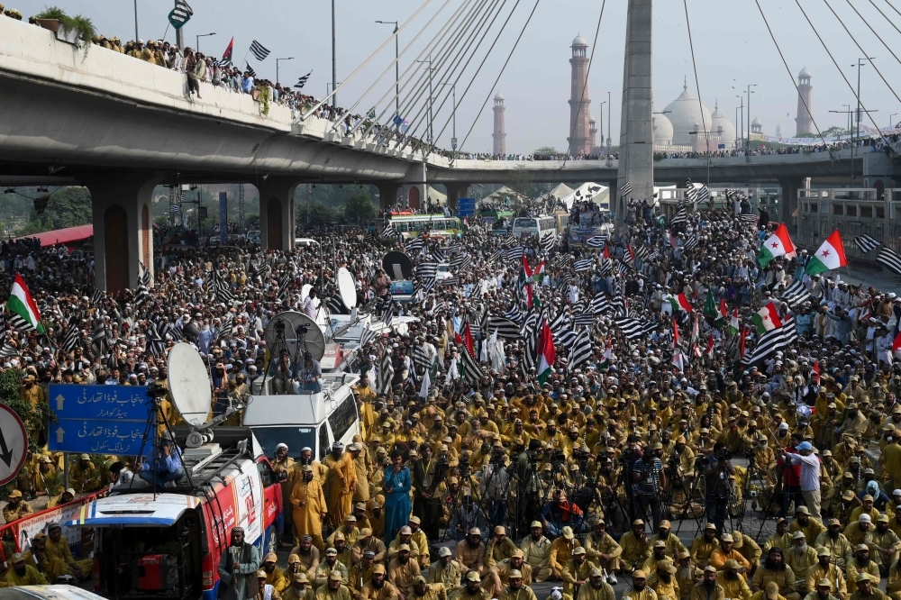 Activists and supporters of the Jamiat Ulema-e-Islam party gather during an anti-government 