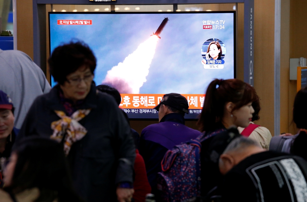People watch a TV broadcast showing a file footage for a news report on North Korea firing two projectiles, possibly missiles, into the sea between the Korean peninsula and Japan, in Seoul, South Korea, on Thursday. — Reuters