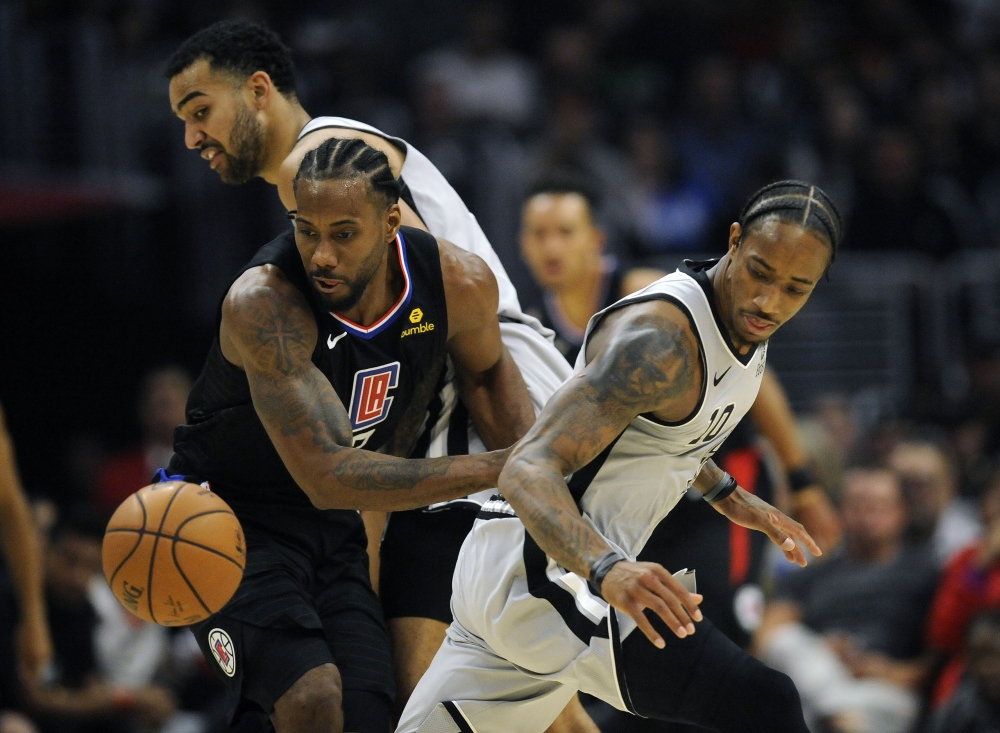 Los Angeles Clippers forward Kawhi Leonard (2) plays for the ball against San Antonio Spurs guard DeMar DeRozan (10) during the second half at Staples Center in Los Angeles, CA, on Thursday. — Reuters