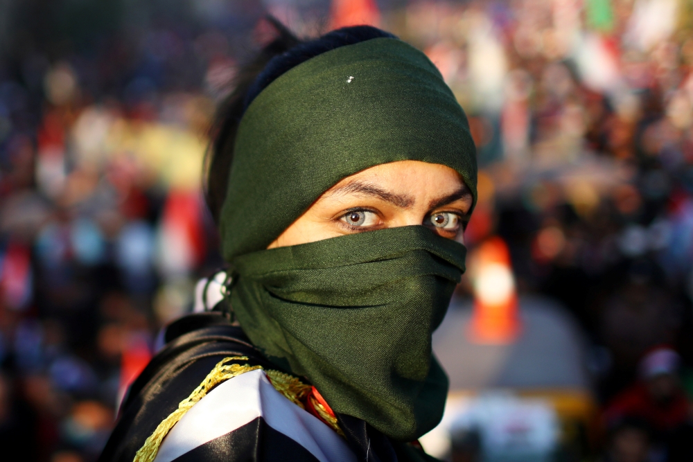 An Iraqi female demonstrator takes part in ongoing anti-government protests in Baghdad on Friday. — Reuters