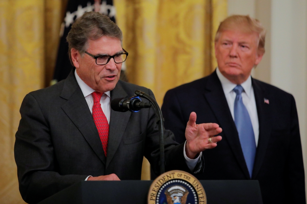 U.S. President Donald Trump listens to U.S. Energy Secretary Rick Perry speak during an event touting the administration's environmental policy in the East Room of the White House in Washington, on July 8, 2019. -Reuters.