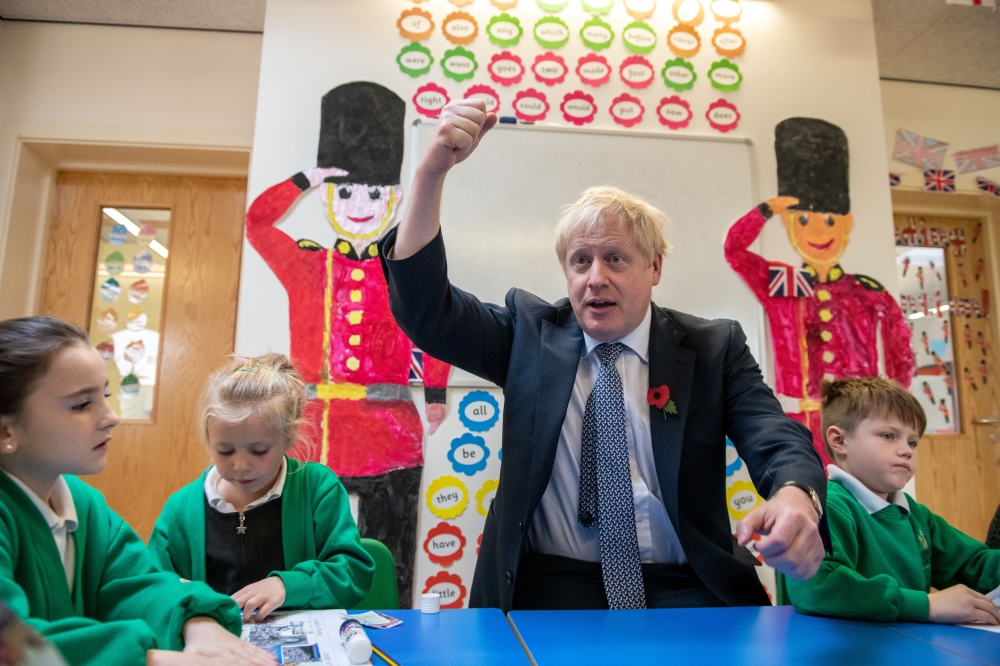 British Prime Minister Boris Johnson visits students at Abbots Green Primary Academy in Bury St Edmunds, Britain October 31, 2019. -Reuters