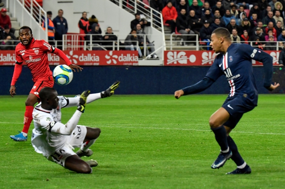Paris Saint-Germain's French forward Kylian Mbappe (R) scores a goal against Dijon's Senegalese goalkeeper Alfred Gomis (2L) during the French L1 football match between Dijon Football Cote-d'Or (DFCO) and Paris Saint-Germain (PSG) at the Gaston Gerard stadium in Dijon, on Friday. — AFP