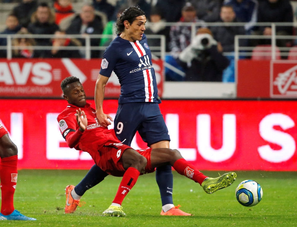 Paris Saint-Germain's French forward Kylian Mbappe (R) scores a goal against Dijon's Senegalese goalkeeper Alfred Gomis (2L) during the French L1 football match between Dijon Football Cote-d'Or (DFCO) and Paris Saint-Germain (PSG) at the Gaston Gerard stadium in Dijon, on Friday. — AFP