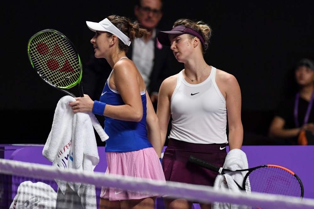 Elina Svitolina of Ukraine hits a return against Belinda Bencic of Switzerland in their women's singles match in the WTA Finals tennis tournament in Shenzhen, on Saturday. — AFP
