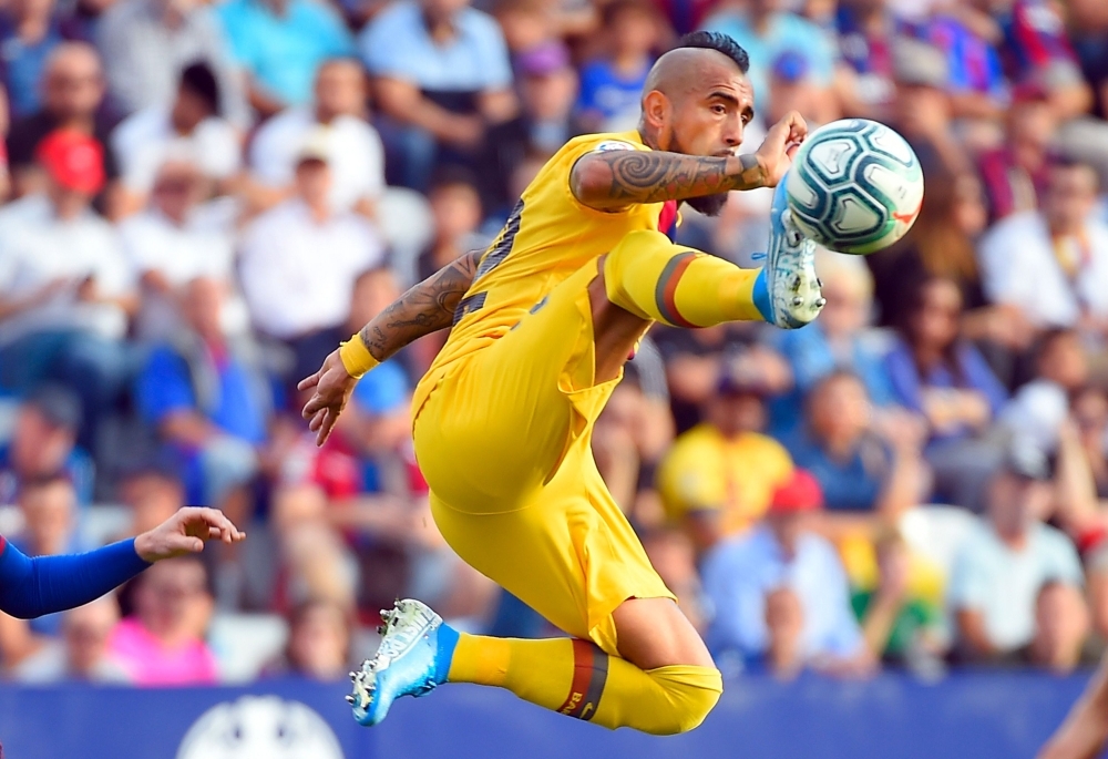 Levante's Spanish goalkeeper Aitor Fernandez (L) vies with Barcelona's Argentinian Forward Lionel Messi during the Spanish League football match between Levante UD and FC Barcelona at the Ciutat de Valencia stadium in Valencia, on Saturday. — AFP