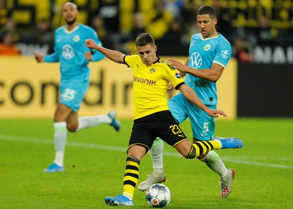 TOPSHOT - Wolfsburg's German forward Lukas Nmecha and Dortmund's German midfielder Mahmoud Dahoud (R) vie for the ball during the German first division Bundesliga football match between Borussia Dortmund and VfL Wolfsburg on November 2, 2019 in Dortmund, western Germany. DFL REGULATIONS PROHIBIT ANY USE OF PHOTOGRAPHS AS IMAGE SEQUENCES AND/OR QUASI-VIDEO 
 / AFP / INA FASSBENDER / DFL REGULATIONS PROHIBIT ANY USE OF PHOTOGRAPHS AS IMAGE SEQUENCES AND/OR QUASI-VIDEO 
