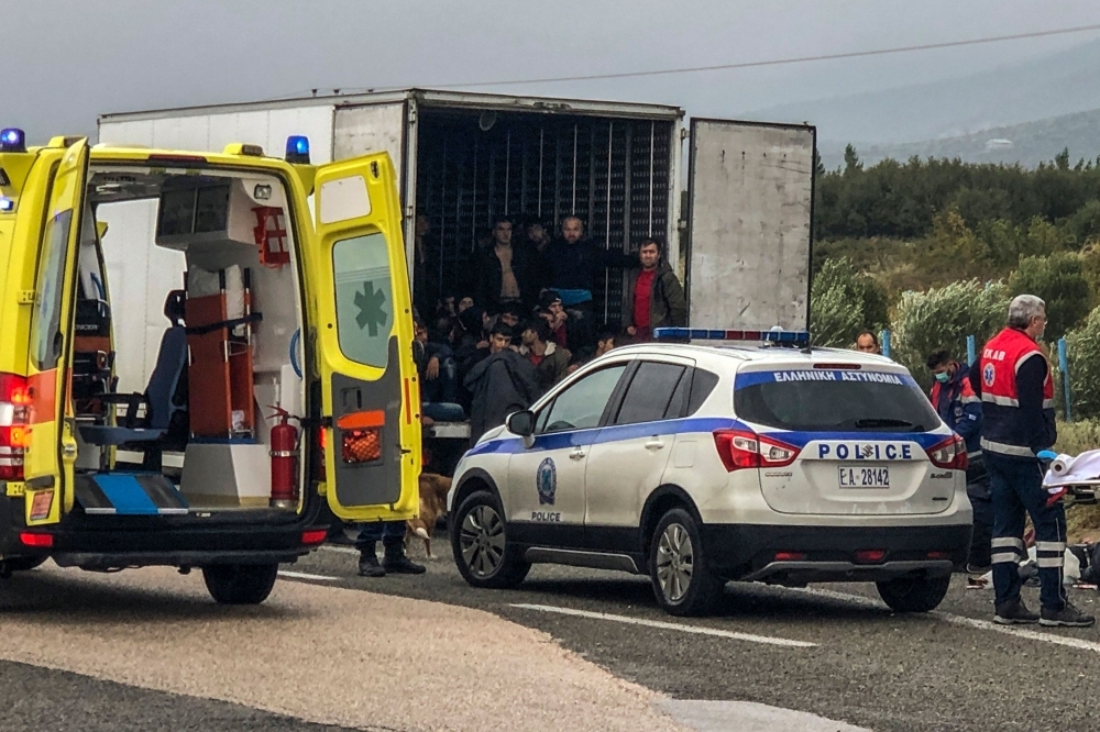 Police and emergency services are at work ti take care of 41 migrants who were found alive in a refrigerated truck near Xanthi, northern Greece, on Monday. — AFP