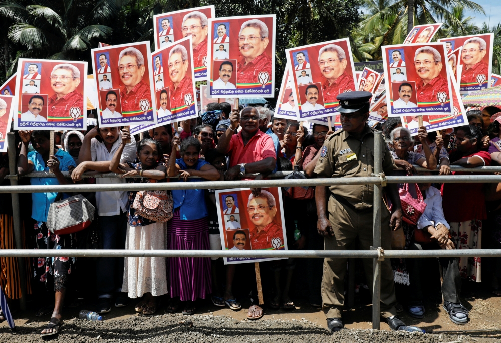 Supporters of Sri Lanka People's Front party presidential election candidate and former wartime defence chief Gotabaya Rajapaksa hold his images during an election campaign rally in Bandaragama, Sri Lanka November 3, 2019. -Reuters