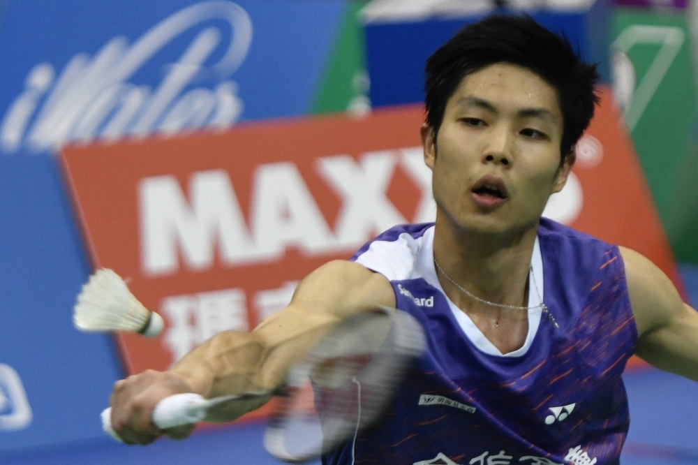 This picture taken on Aug. 30, 2019, shows world number two badminton player Chou Tien-chen of Taiwan checking his racket during an interview with Agence France-Presse in Taipei. Chou Tien-chen is taking the unusual step of gearing up for the 2020 Olympics without a coach, with his longtime physio and confidante shepherding him towards Tokyo gold. — AFP