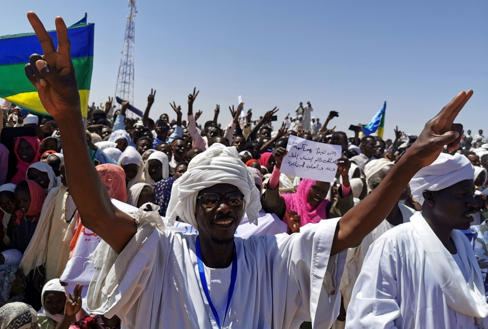 Civilians celebrate during a visit by Sudan's Prime Minister in the transitional government Abdalla Hamdok to the camps of El-Fashir in North Darfur, Sudan on Monday. -Reuters