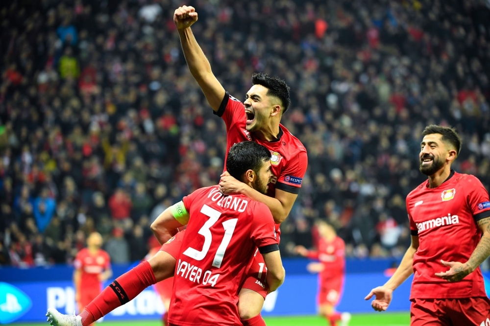 Leverkusen's German forward Kevin Volland, left, celebrates scoring the 2-0 goal with his team-mate German midfielder Nadiem Amiri, center, and German midfielder Kerem Demirbay, right, during the UEFA Champions League Group D football match Bayer Leverkusen v Atletico Madrid in Leverkusen, western Germany, on Wednesday. — AFP