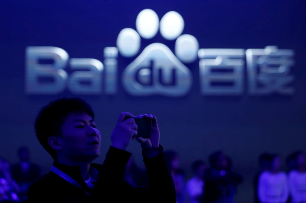 A man takes pictures at the 2018 Baidu World conference and exhibit in Beijing, China, in this Nov. 1, 2018 file photo. — Reuters