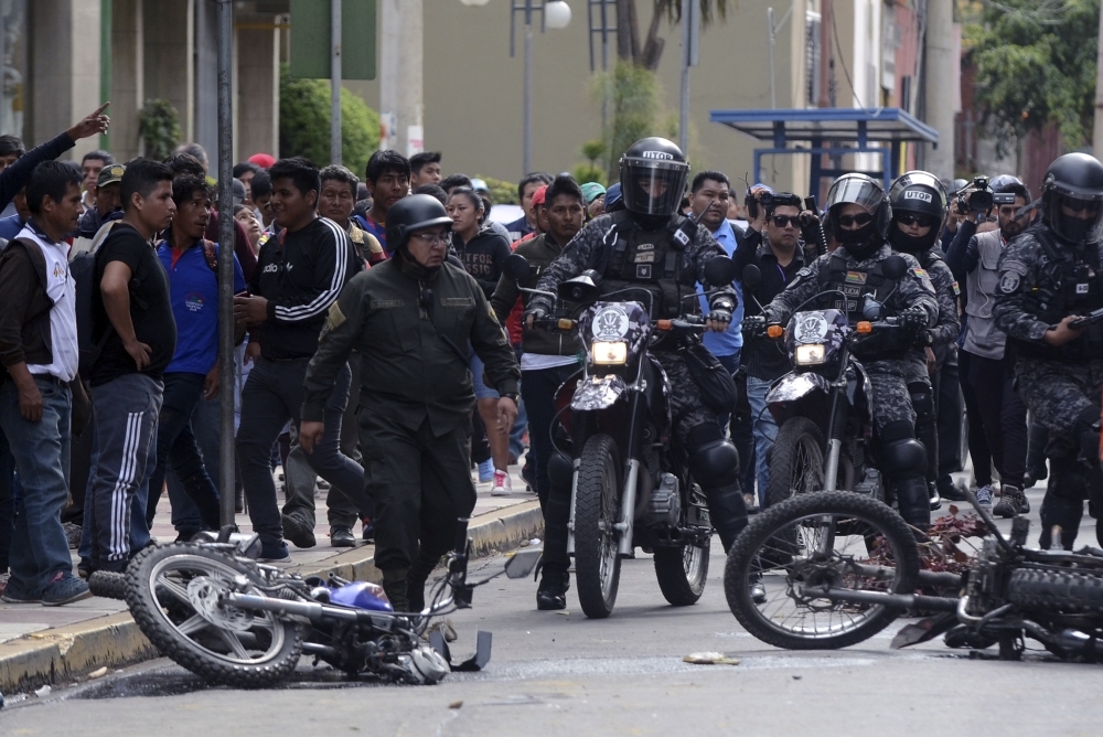 Riot police clash with supporters of the Movimiento Al Socialismo (MAS) during a rally in support of Bolivia's President Evo Morales in Cochabamba, Bolivia, on Wednesday. — AFP