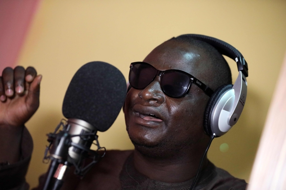 Yahaya Usman, popularly called Yahaya Makaho, a blind singer who rose from being a street beggar to a famously known singer in northern Nigeria, sings while wearing his trademark sunglasses in Kaduna, Nigeria, in this Sept. 25, 2019 file photo. — AFP