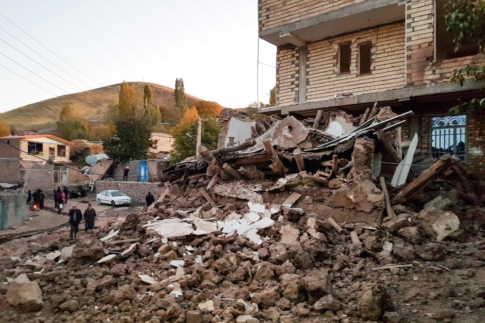 The debris of buildings in the Iranian village of Varnakesh, about 120 km (75 miles) southeast of the city of Tabriz, in East Azerbaijan Province, is seen following a 5.9-magnitude earthquake. — AFP