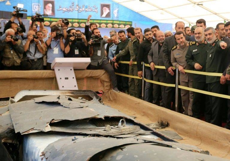 The debris of a US drone Iran claimed to have shot down over the Gulf in June this year is on display in a special exbition in Tehran in this file photo. — AFP