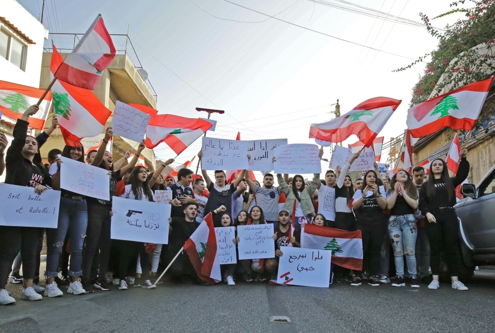 Lebanese demonstrators gather during an anti-government protest in the northern Lebanese town of Amioun near the port city of Tripoli on Friday. -AFP 