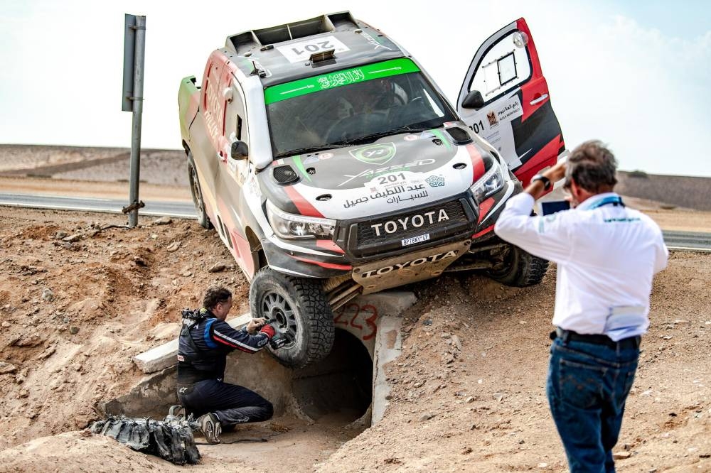 The top three in AlUla-Neom Rally are seen on the podium.