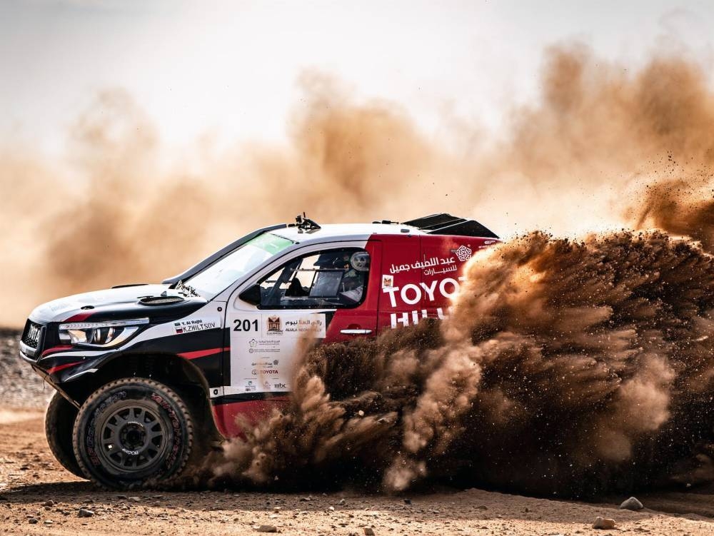 The top three in AlUla-Neom Rally are seen on the podium.