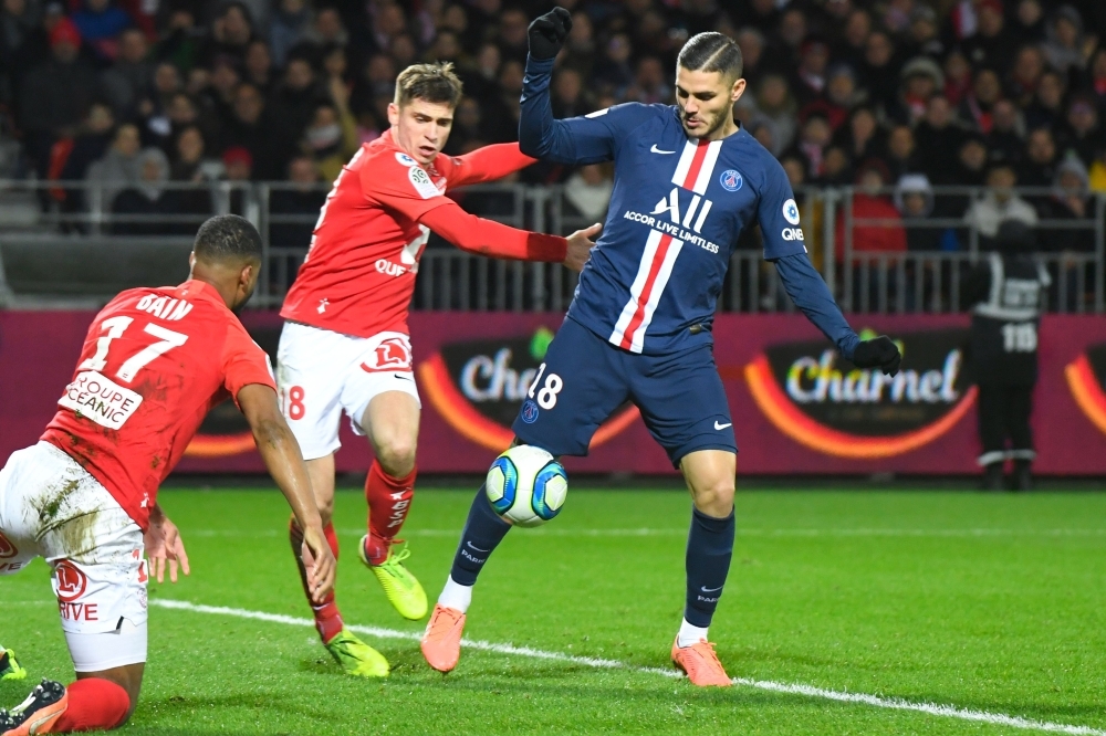 Paris Saint-Germain's Argentine forward Mauro Icardi (R) vies with Brest's players before scoring a goal during the French L1 football match between Stade Brestois 29 and Paris Saint-Germain in Brest, western France on Saturday. — AFP
