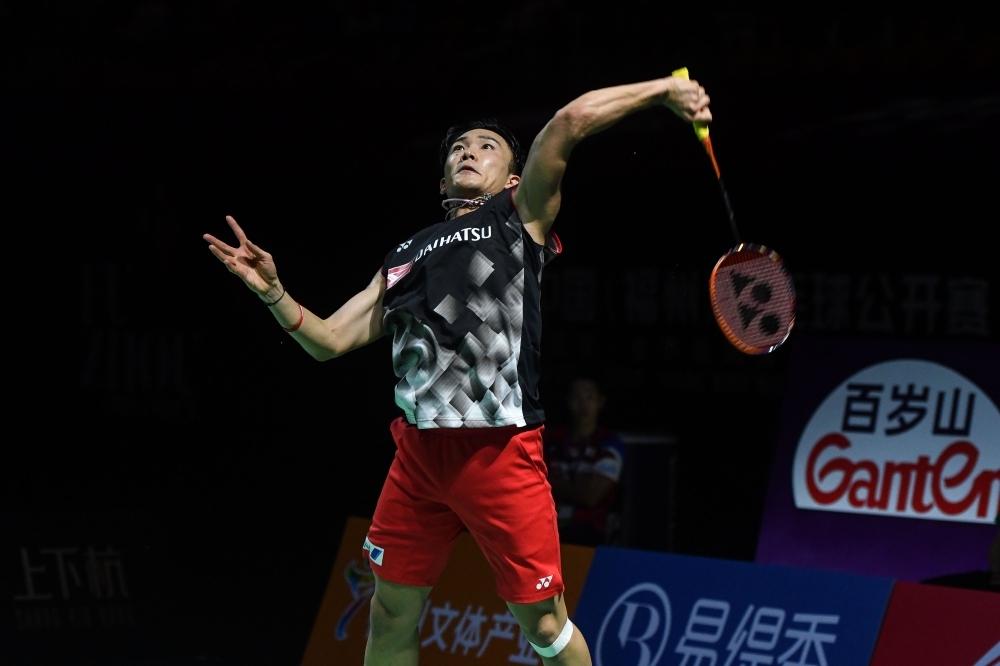 Kento Momota of Japan hits a return against Chou Tien-chen of Taiwan during their men's singles final match at the Fuzhou China Open badminton tournament in Fuzhou in China's eastern Fujian province on Sunday. — Reuters