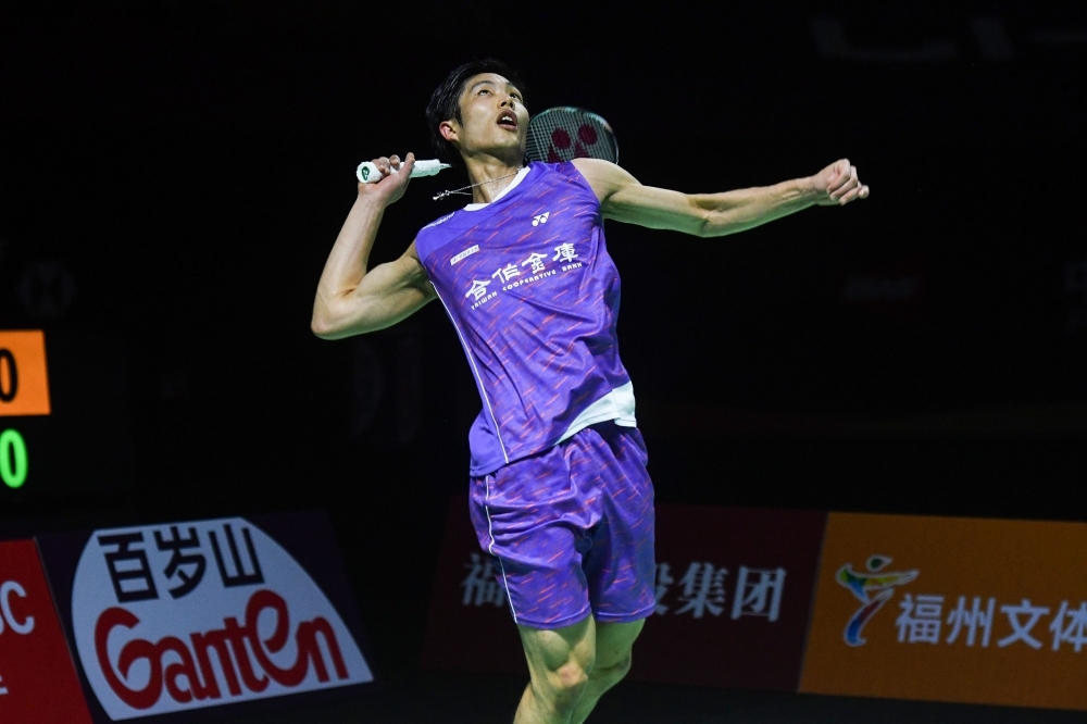 Kento Momota of Japan hits a return against Chou Tien-chen of Taiwan during their men's singles final match at the Fuzhou China Open badminton tournament in Fuzhou in China's eastern Fujian province on Sunday. — Reuters