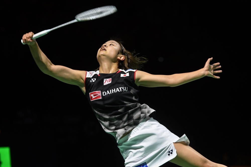 Kento Momota of Japan hits a return against Chou Tien-chen of Taiwan during their men's singles final match at the Fuzhou China Open badminton tournament in Fuzhou in China's eastern Fujian province on Sunday. — Reuters