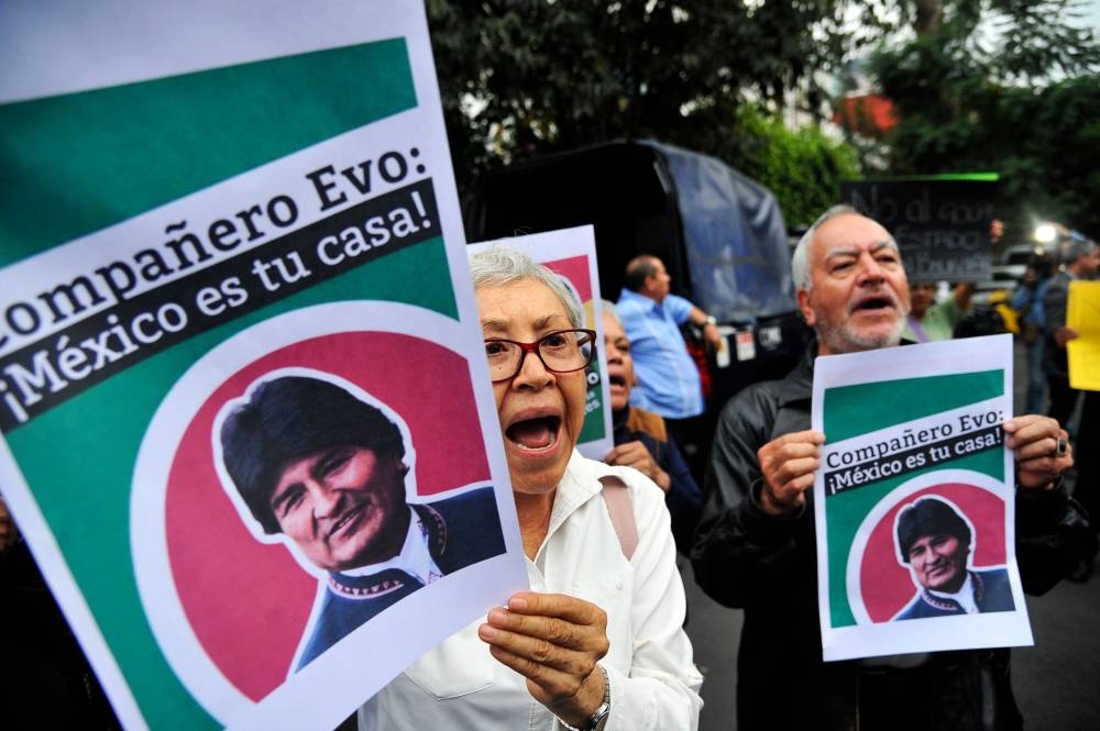 People demonstrate in support of Bolivian ex-President Evo Morales, holding a banner that reads 'It's not a resignation, It's a coup', in front of the Bolivian embassy in Mexico City, on Monday. - AFP