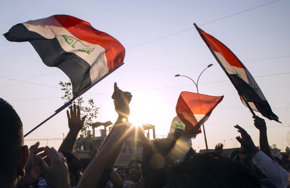 Iraqis demonstrate outside the Basra Governorate's building on Monday in the southern city of Basra. -AFP