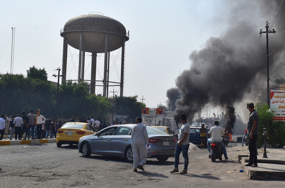 Iraqis demonstrate outside the Basra Governorate's building on Monday in the southern city of Basra. -AFP