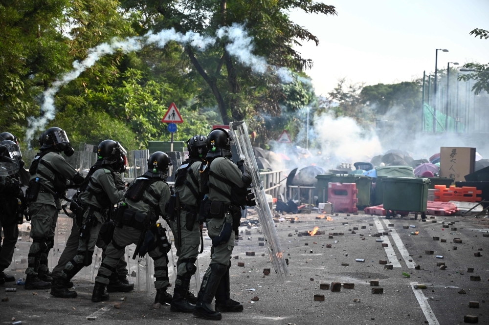 Police fire tear gas towards protesters at the Chinese University of Hong Kong (CUHK), in Hong Kong on Tuesday. -AFP 