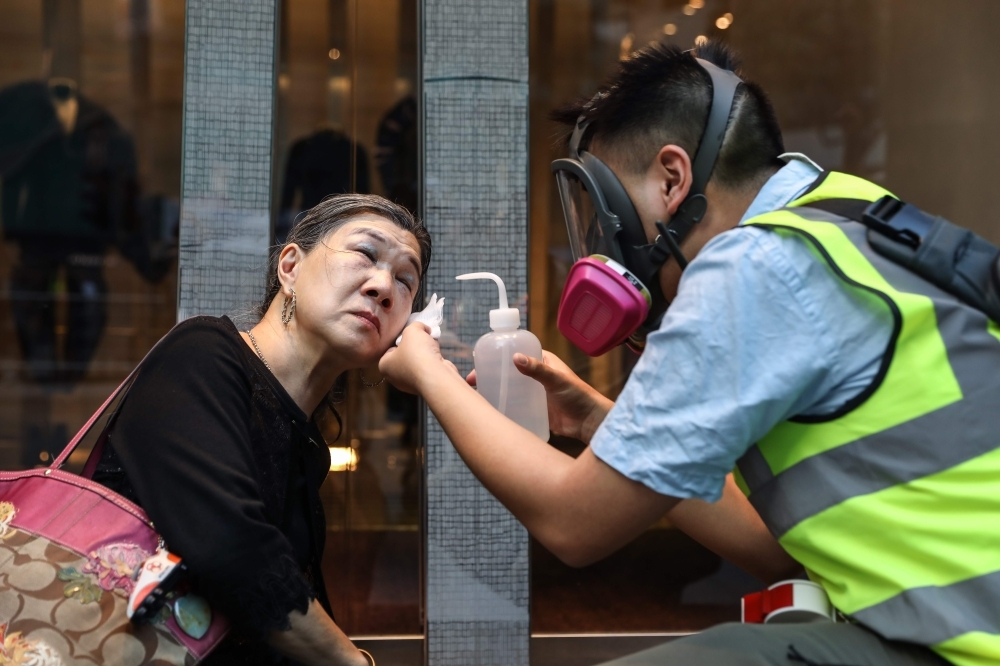 Police fire tear gas towards protesters at the Chinese University of Hong Kong (CUHK), in Hong Kong on Tuesday. -AFP 