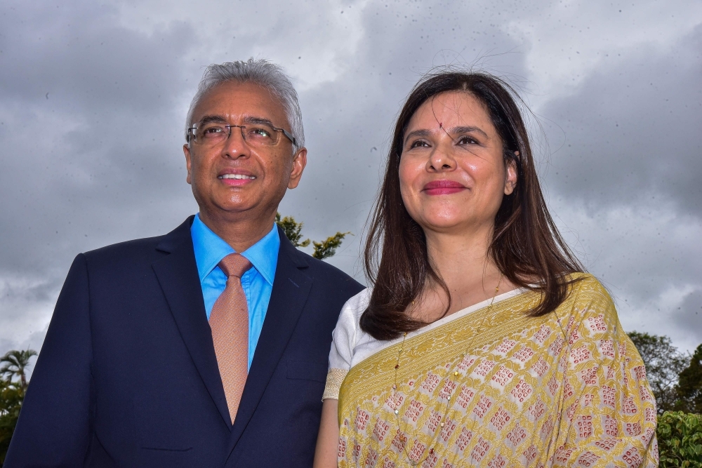 Mauritius’ re-elected Prime Minister Pravind Jugnauth, front, second left, poses with President Barlen Vyapoory, front, center, and his Cabinet after his swearing-in ceremony at the state house in Reduit on Tuesday. — AFP