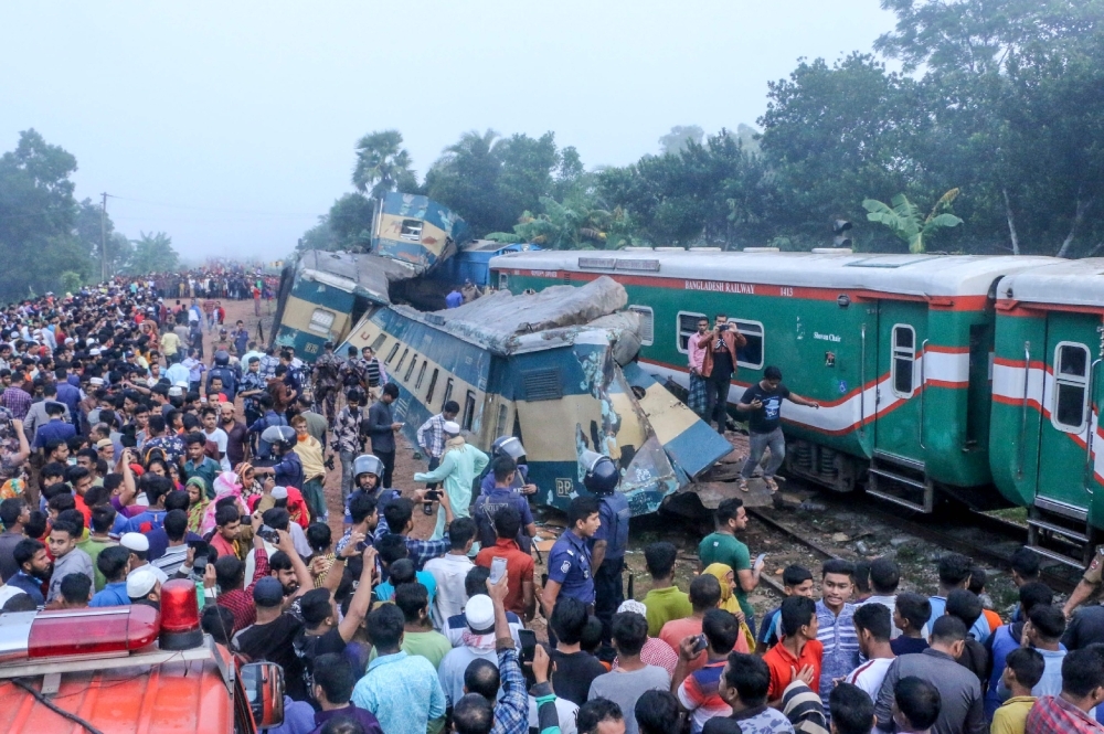 Bystanders look on after a train collided with another train in Brahmanbaria some 130 km from Dhaka on Tuesday. — AFP