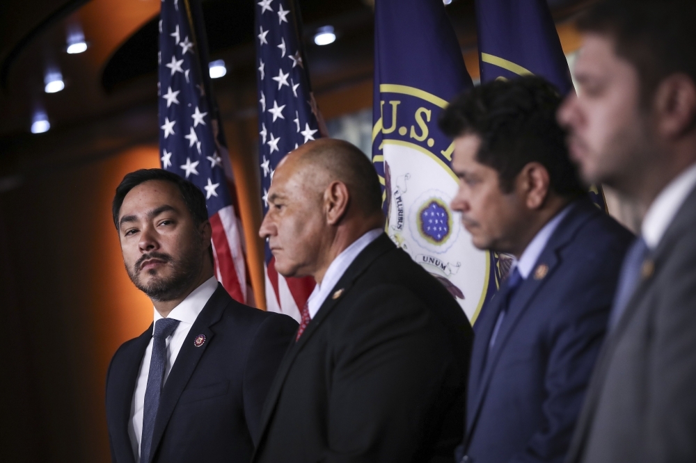 At left, Congressional Hispanic Caucus chairman Rep. Joaquin Castro (D-TX) looks on during a news conference to discuss the Supreme Court case involving Deferred Action for Childhood Arrivals (DACA) at the U.S. Capitol on Tuesday in Washington, DC. -AFP