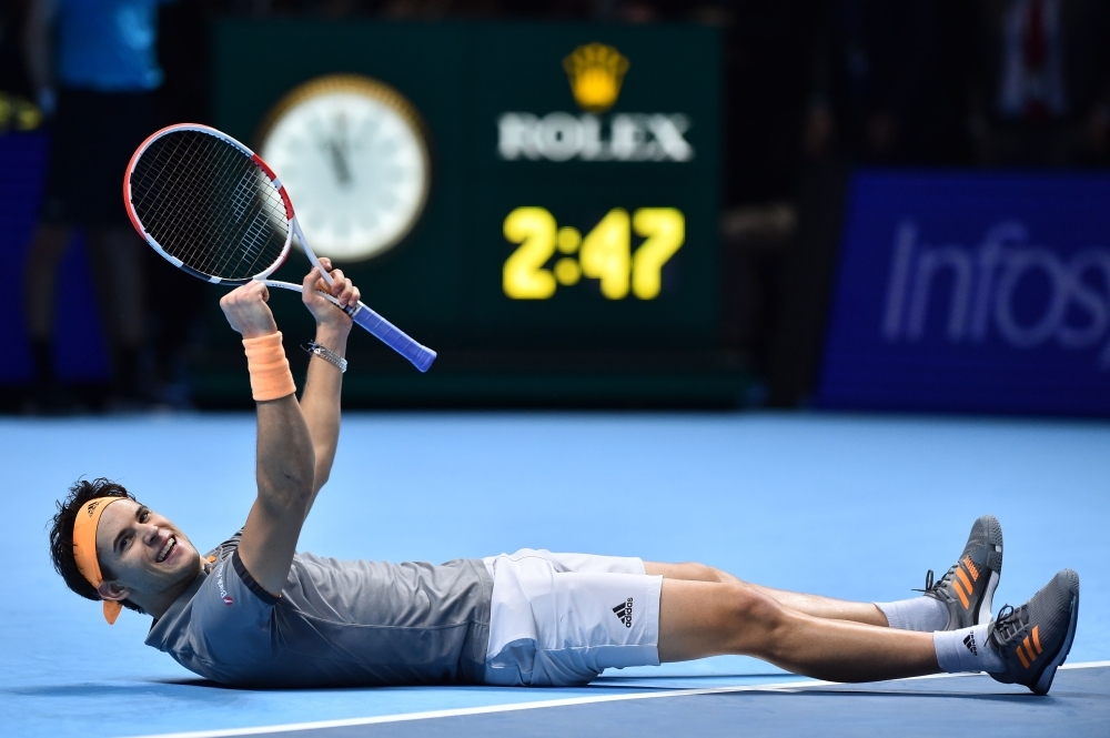 Austria's Dominic Thiem celebrates victory against Serbia's Novak Djokovic during their men's singles round-robin match on day three of the ATP World Tour Finals tennis tournament at the O2 Arena in London on Tuesday. Austria's Dominic Thiem beat Serbia's Novak Djokovic 6-7; 6-3; 7-6. — AFP